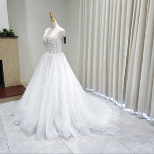 White wedding dress on a mannequin against a neutral background